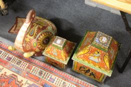Two decorative Indian painted boxes and covers together with a similar model of an elephant's head.
