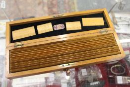 A boxed set of box wood rules together with a slide rule.