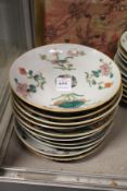 Ten Chinese floral decorated saucer dishes.