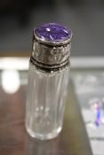 A silver topped scent bottle.