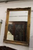 A modern gilt framed mirror.