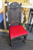 An 18th century oak high back hall chair with carved decoration.