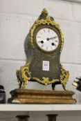 A French green tortoiseshell and ormolu mantle clock in the manner of Boulle.