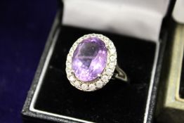 A dress ring set with a large amethyst coloured stone.