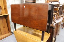 A mahogany drop leaf dining table.