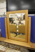 A modern light oak dressing table mirror.