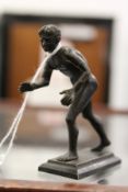 After the antique, a small bronze male athlete.