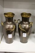 A pair of bronze colour metal vases.