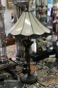 An Art Nouveau style lamp base modelled as a standing female nude with an opaque glass shade.
