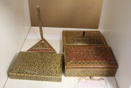 Three Persian boxes and a similar pen stand.