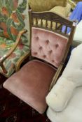A Victorian oak framed and upholstered armchair.