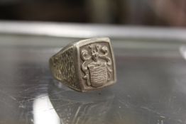 A silver ring with crest.
