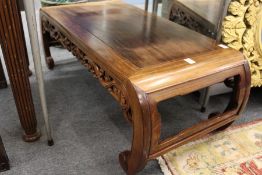 A Chinese hardwood low table with curving ends.