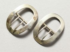 A small pair of silver buckles.