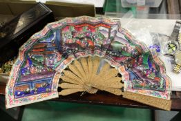 A good Chinese carved sandalwood and painted paper fan, in a lacquer case.