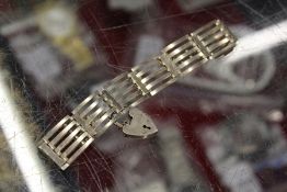 A silver gate bracelet.