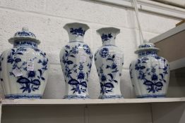 A garniture of blue and white vases and jars.