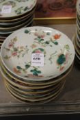Ten small Chinese floral decorated saucers.
