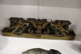 A carved wood and polychrome decorated group depicting angels.