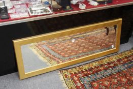A modern rectangular gilt framed wall mirror.