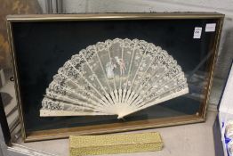 A framed and glazed lace fan.