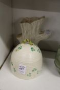 A Belleek honey bowl and cover and a similar vase.