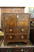 a 19th century mahogany commode with two doors and two long drawers on bracket feet.
