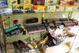 A good collection of O gauge railway locomotives, carriages and accessories together with a tin-