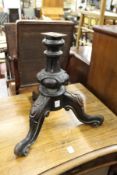 A Victorian tripod base of a music seat.