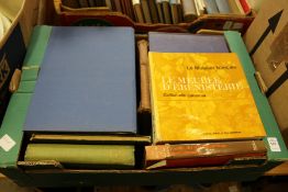 A box of art and antique reference books.