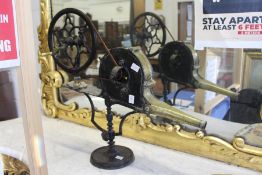 A 19th century cast iron and brass mechanical bellows.