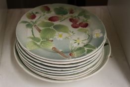 A group of French fruit decorated plates and bowl.