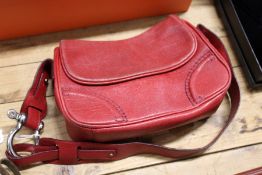 A Burberry red leather handbag.