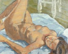 Early 20th century British school, a study of a reclining female nude in the artist's studio, oil on