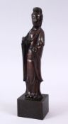 A CHINESE BRONZE FIGURE OF GUANYIN, in traditional robes, on a fitted base, 15cm ( excluding
