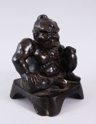 A GOOD JAPANESE MEIJI PERIOD BRONZE FIGURE OF SEATED ONI, in a seated position with a meaningful