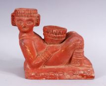AN EGYPTIAN TERRACOTTA / TOPHANE POTTERY FIGURE OF A RECLINING MAN, 16cm high x 21cm