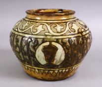 A GOOD EARLY ISLAMIC POTTERY CALLIGRAPHIC VASE, with a green / brown glaze with bands of