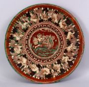 A 19TH CENTURY OR EARLIER INDIAN POTTERY DISH, with poly chrome decoration depicting a multi