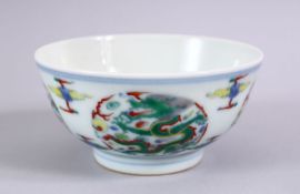 A CHINESE YONGZHENG STYLE DOUCAI DRAGON PORCELAIN RICE BOWL, decorated with roundel of dragons