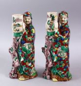 A PAIR OF JAPANESE MEIJI PERIOD KUTANI PORCELAIN CANDLE STICK FIGURES, in the form of two figures