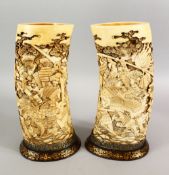 A FINE PAIR OF JAPANESE MEIJI PERIOD CARVED IVORY SAMURAI TUSK VASES, the vases finely and deeply