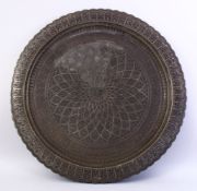 A LARGE PERSIAN TINNED COPPER TRAY, MID 20TH CENTURY, engraved a radiating palmette design, within a