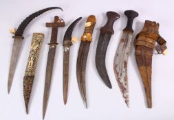 A COLLECTION OF 6 ISLAMIC AND TRIBAL DAGGERS - one with a carved bone sheath, some decorated