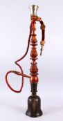 A 19TH CENTURY ISLAMIC HUQQA BASE & PIPE, the base with mixed alloy decoration, 79cm high.