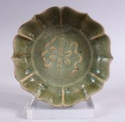 A CHINESE SONG STYLE CRACKLE GLAZED PORCELAIN DISH, with raised precious object decoration, the base