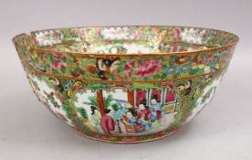 A LARGE 19TH CENTURY CHINESE CANTON FAMILLE ROSE PORCELAIN BOWL, with panel decoration of figures,