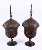 A FINE PAIR OF 19TH CENTURY PERSIAN QAJAR GOLD INLAID STEEL LIDDED URNS, with gold inlaid borders to