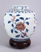 A FINE CHINESE UNDERGLAZE BLUE & COPPER RED PORCELAIN JAR & STAND, the jar with underglaze blue