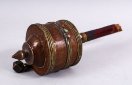 A 19TH CENTURY TIBETAN PRAYER WHEEL - containing a manuscript, with inlaid semi precious stones,